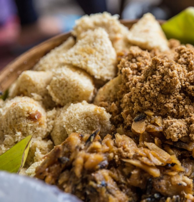 A variety of traditional Rwandan dishes, including Ugali, Isombe, Brochettes, and Akabenz, showcasing the country's rich culinary heritage