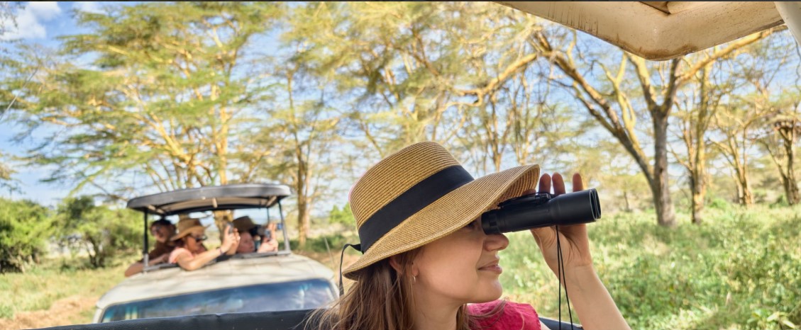 Tourist on safari watching elephants near Mount Kilimanjaro in East Africa