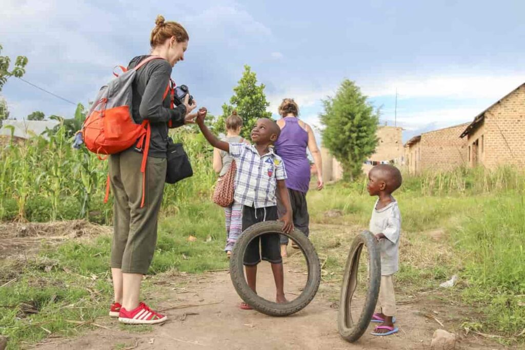 How do I greet locals in Luganda?